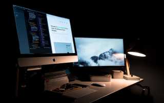 desktop iMac computers at night