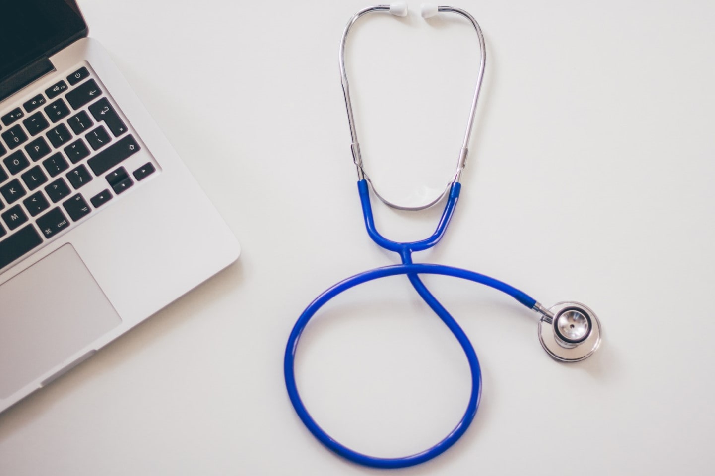 laptop computer and stethoscope to diagnose issues