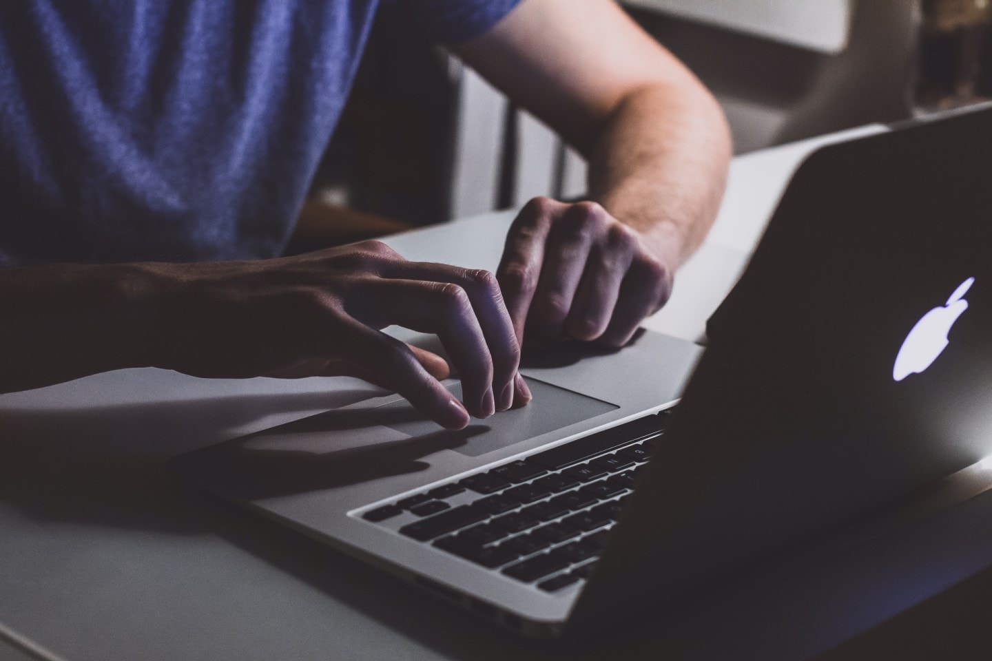 man using Macbook laptop