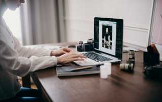 Woman editing photos on Macbook laptop