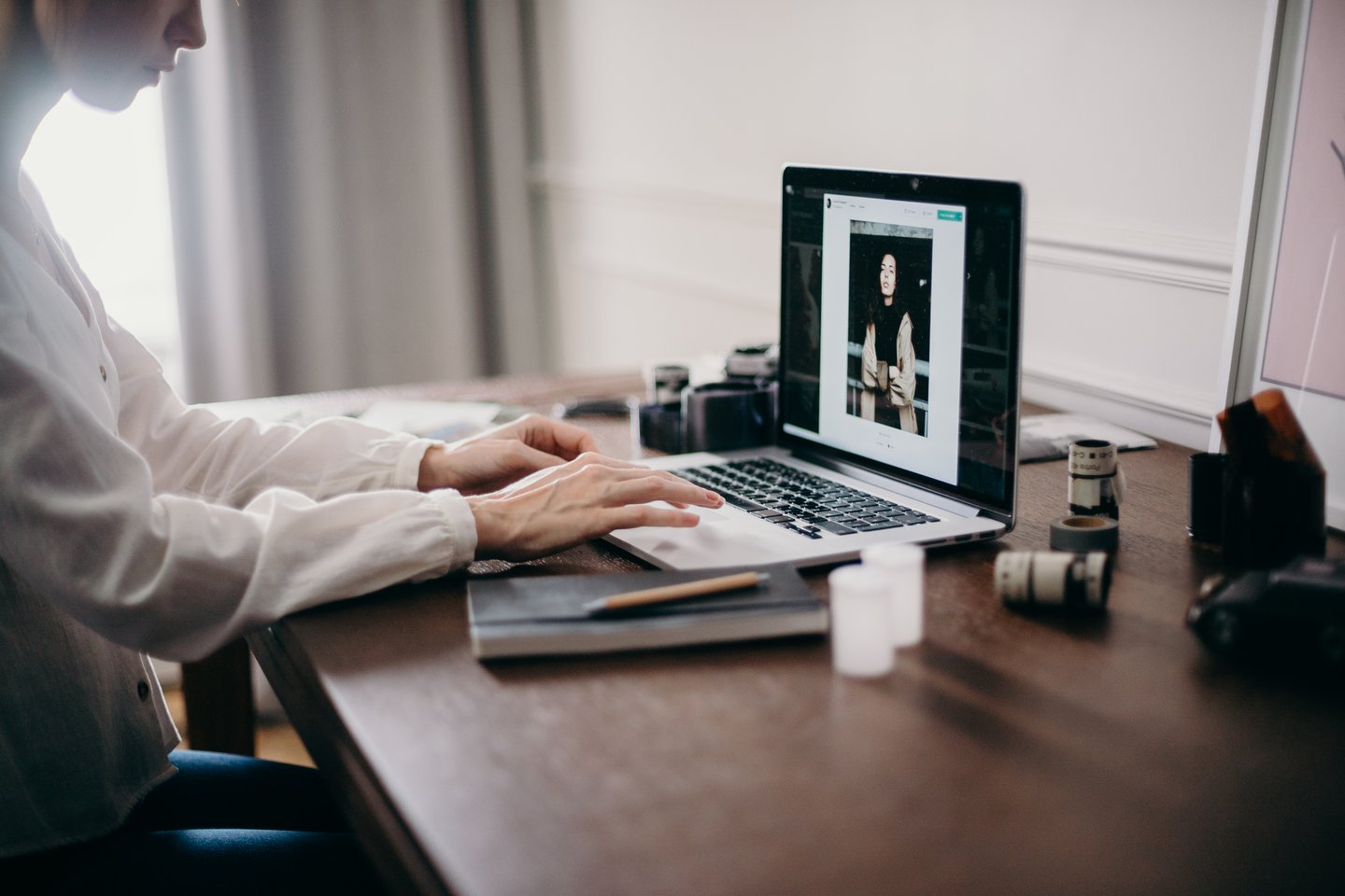 Woman editing photos on Macbook laptop