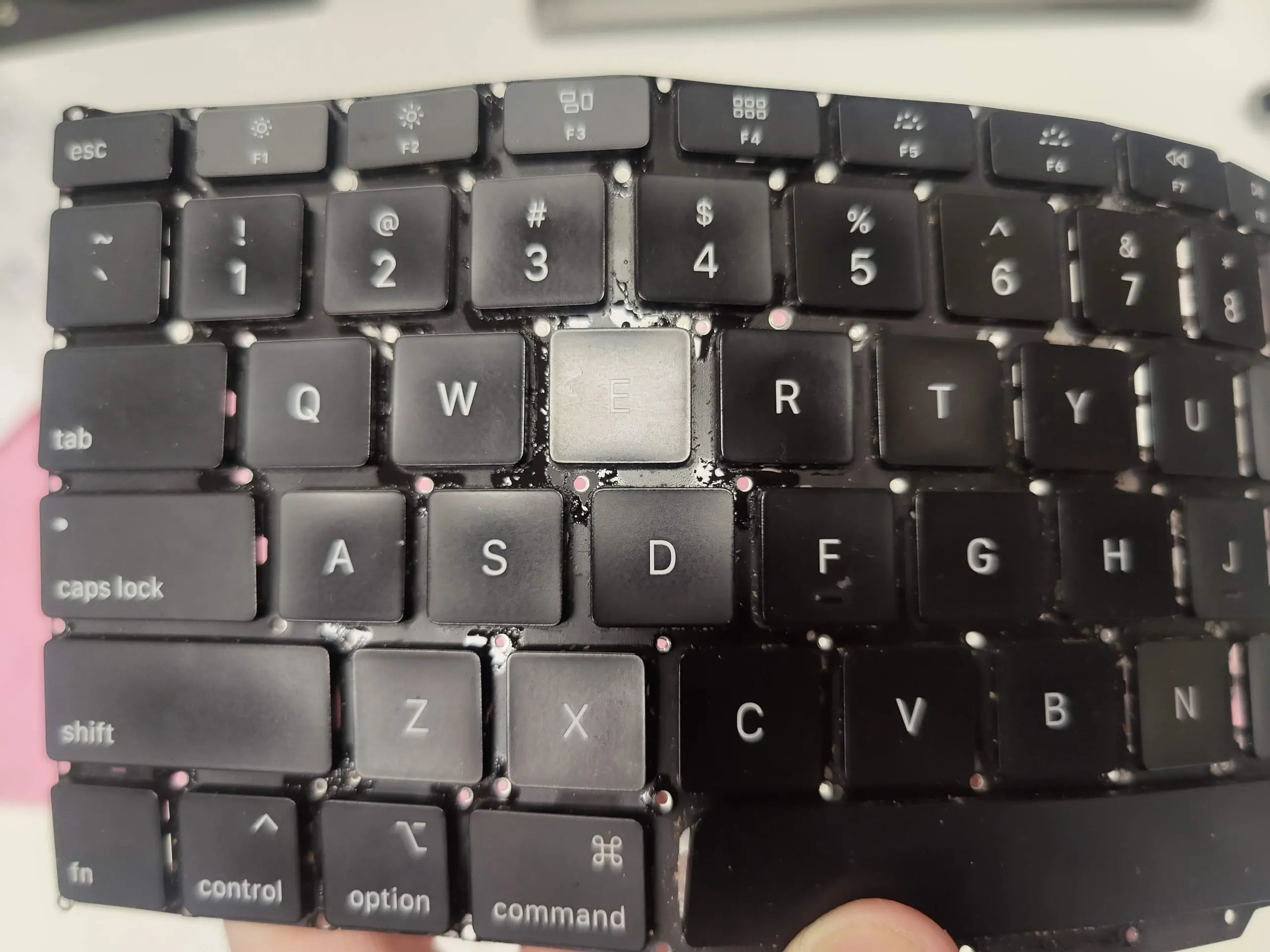 Sticky liquid residue on Apple MacBook Air M1 keyboard Sticky liquid residue on Apple MacBook Air M1 keyboard