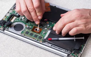 man fixing his laptop