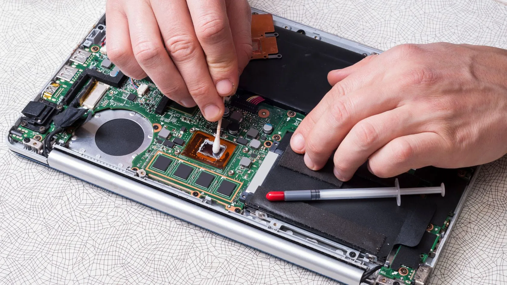 man fixing his laptop